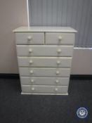 A contemporary cream seven drawer chest