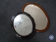 An inlaid mahogany oval framed bevelled mirror together with one other mahogany mirror
