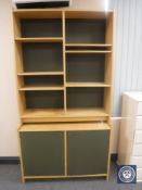 A set of late twentieth century beech effect bookshelves fitted with cupboard below