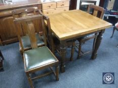 A twentieth century oak pull out dining table together with four chairs