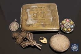 A 9ct gold padlock, a silver plated US $1 cigarette case, silver filigree brooch,