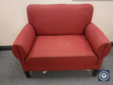 An early twentieth century drop end settee upholstered in red fabric