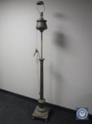 An antique brass rise and fall standard lamp