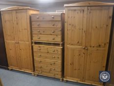 A four piece pine bedroom suite comprising of pair of double door wardrobes,