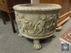 A pair of composition classical style garden urns on paw feet,