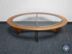 An oval teak G-plan 'Astro' coffee table with glass inset panel CONDITION REPORT: