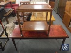 A mahogany extending leather topped coffee table together with a two tier trolley