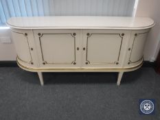 A white and gilt painted D-shaped four door sideboard