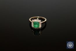 A 15ct yellow gold emerald and diamond ring, the square emerald-cut medium green emerald weighing 1.