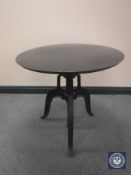 An industrial style circular metal adjustable bar table