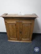 An antique pine double door wall cabinet