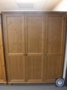 An Ikea pine triple door wardrobe