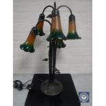 A contemporary metal five way table lamp with coloured glass fluted shades