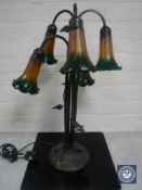 A contemporary metal five way table lamp with coloured glass fluted shades
