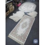 Two fringed Indian rugs on cream ground together with two sheep skin rugs