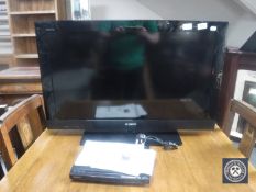 A Sony Bravia 32" LCD TV with remote together with a Sony DVD player with remote