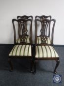 A set of four contemporary Queen Anne style dining chairs upholstered in striped fabric