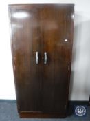 A twentieth century mahogany double door hanging wardrobe