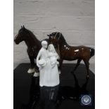 A Royal Doulton horse, front leg raised in brown gloss finish,