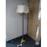 An ornate gilt standard lamp with shade