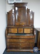 A late nineteenth century mahogany barrel fronted bureau fitted with cupboards above