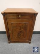 An antique mahogany cupboard fitted a drawer with pillar supports