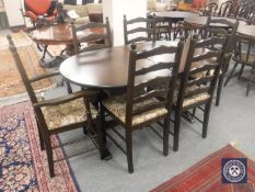 An oval oak extending dining table with leaf,