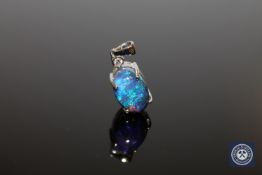 A 14ct white gold opal an diamond pendant, the solid, cabochon opal weighing 7.