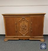 A continental carved oak side cabinet,