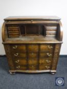 A continental oak barrel fronted bureau