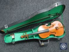 A student violin with bow in case