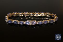 A 14ct yellow gold diamond and tanzanite tennis bracelet,