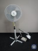 An electric oscillating floor fan and lamp