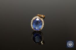 An 18ct yellow gold tanzanite and diamond pendant, the oval-cut tanzanite weighing 5.