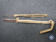 Two split cane fly rods, one in Hardy's bag.