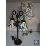 A metal table lamp with two Tiffany style shades together with a brass and marble table lamp with