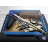 A box of tin whistles, harmonica, brass pocket lighter, cased dominoes,