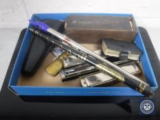 A box of tin whistles, harmonica, brass pocket lighter, cased dominoes,