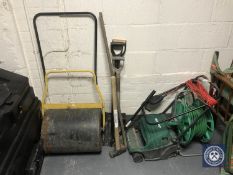 A Qualcast lawn raker together with a hose pipe on reel,