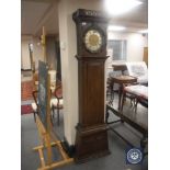 A continental oak longcase clock with metal dial,