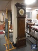A continental oak longcase clock with metal dial,