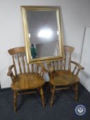 A pair of kitchen armchairs together with a gilt framed mirror