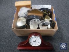 A box containing a quantity of contemporary battery operated clocks