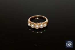 A yellow metal five pearl ring, size L 1/2.