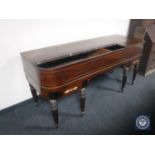 A 19th century inlaid mahogany table piano case on reeded legs
