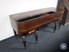 A 19th century inlaid mahogany table piano case on reeded legs