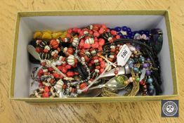 A box of costume jewellery, silver plated cutlery, beaded necklace etc.