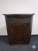 A Georgian oak hanging corner cupboard