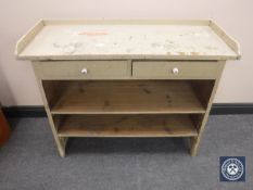 An early twentieth century painted side table fitted with two drawers