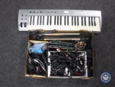 An M-Audio Key Studio 491I keyboard together with a box containing two Sennheiser free ports,